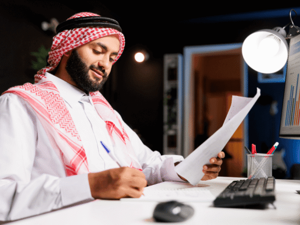 man-diligently-working-his-desk-for-tax